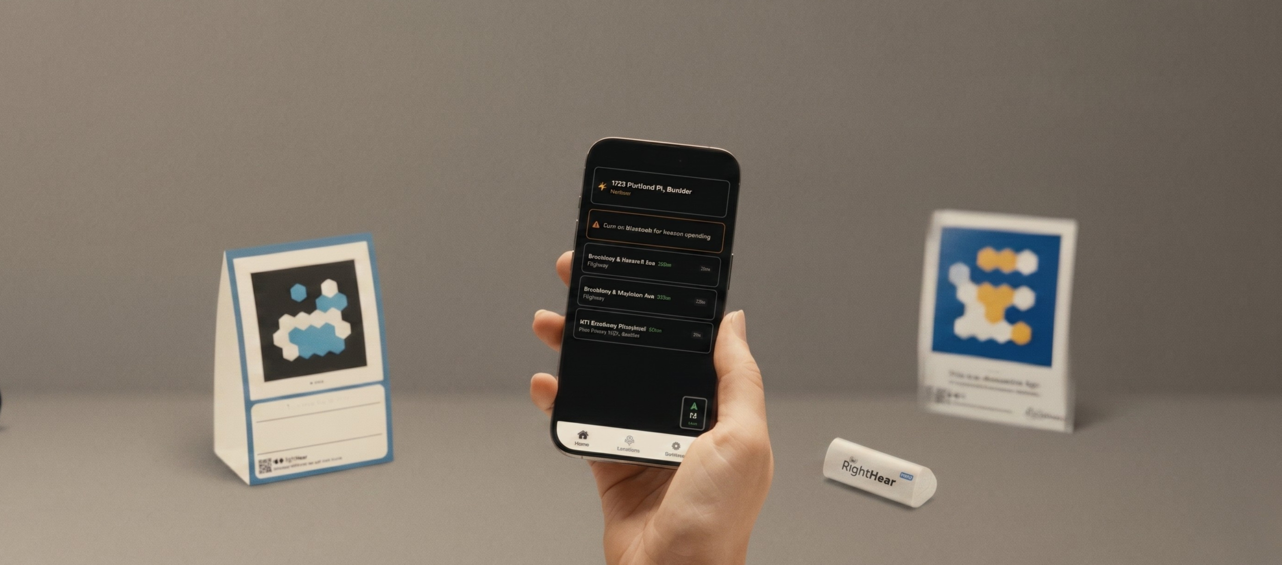 The RightHear app in an iPhone device next to 2 markers and one beacon.